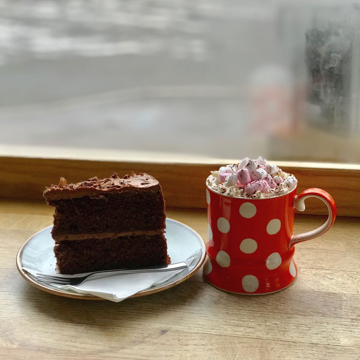 Chocolate cake and a hot drink photographed at stop. coffee